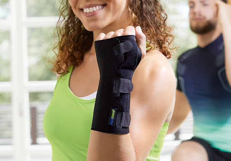 Woman smiling while doing exercise with a wrist support on Woman smiling while doing exercise with a wrist support on
